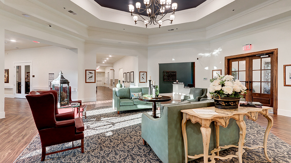 Spacious foyer at Ridgemere Senior Living with comfortable seating, decorative lighting, and a welcoming entrance designed for residents and guests.